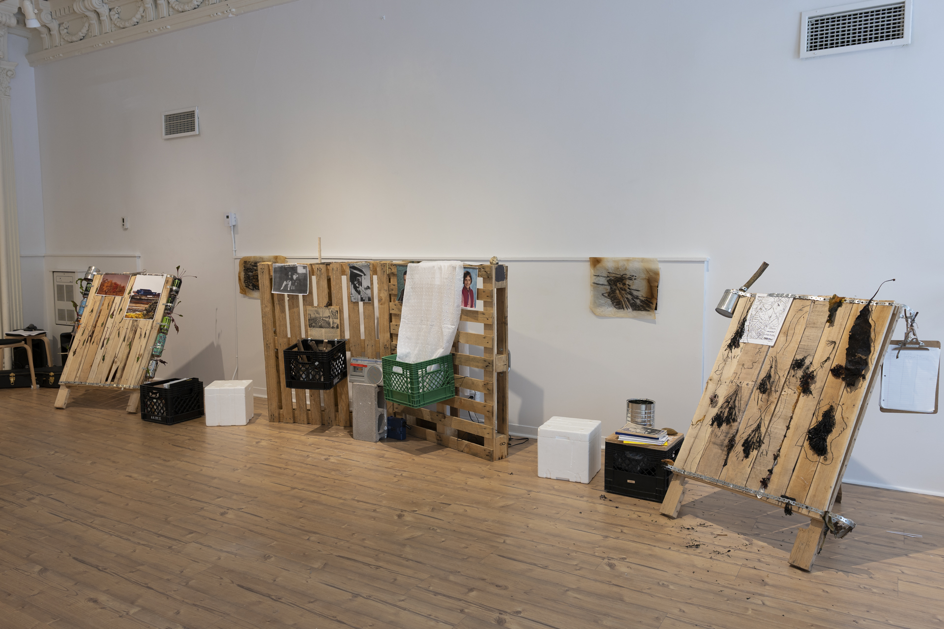 Installation view of pallet-based altar structures in the gallery